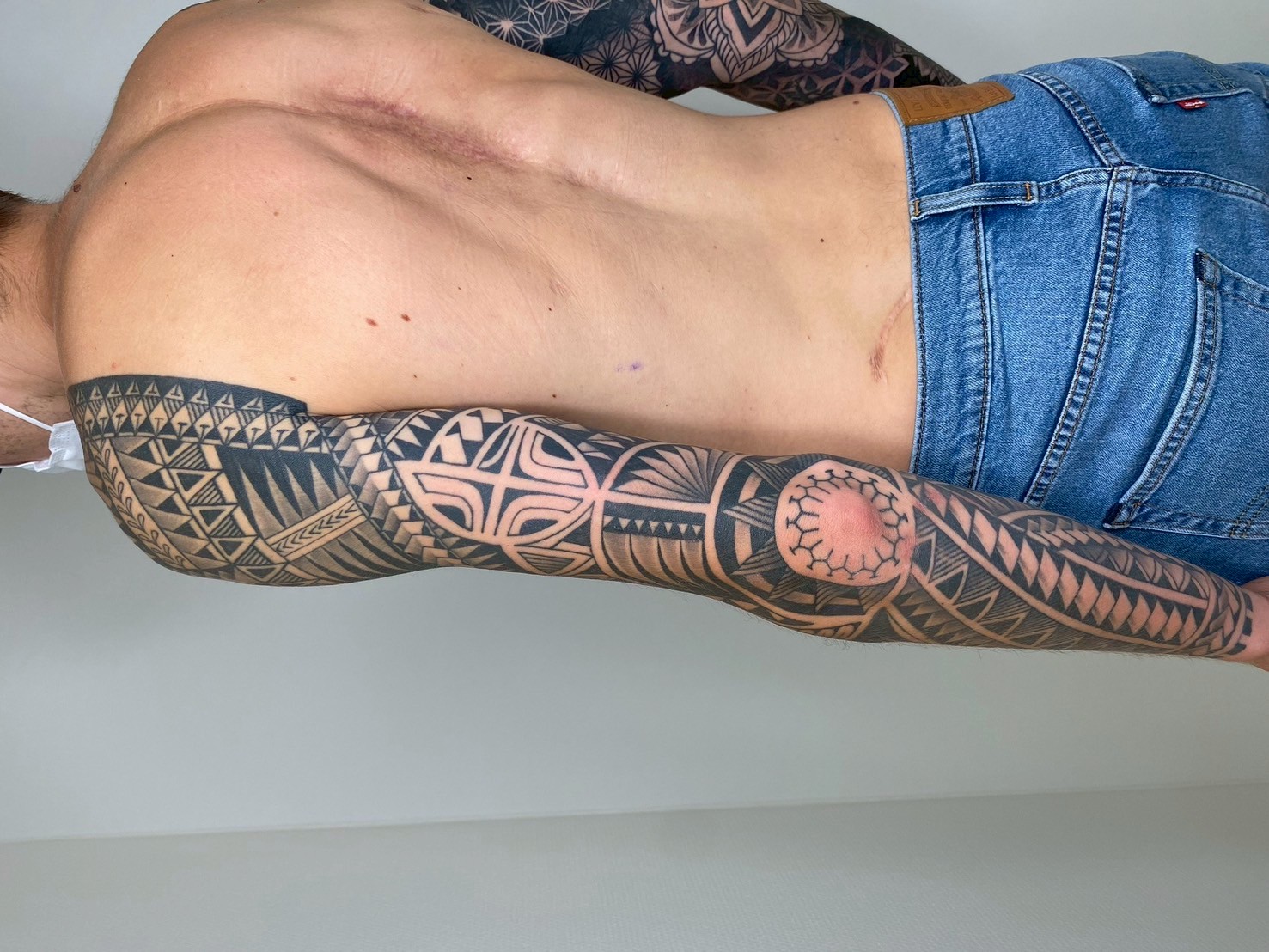 Polynesian tribal full sleeve tattoo, back view