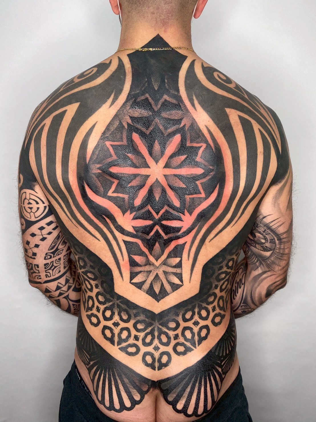 Geometric blackwork full back tattoo