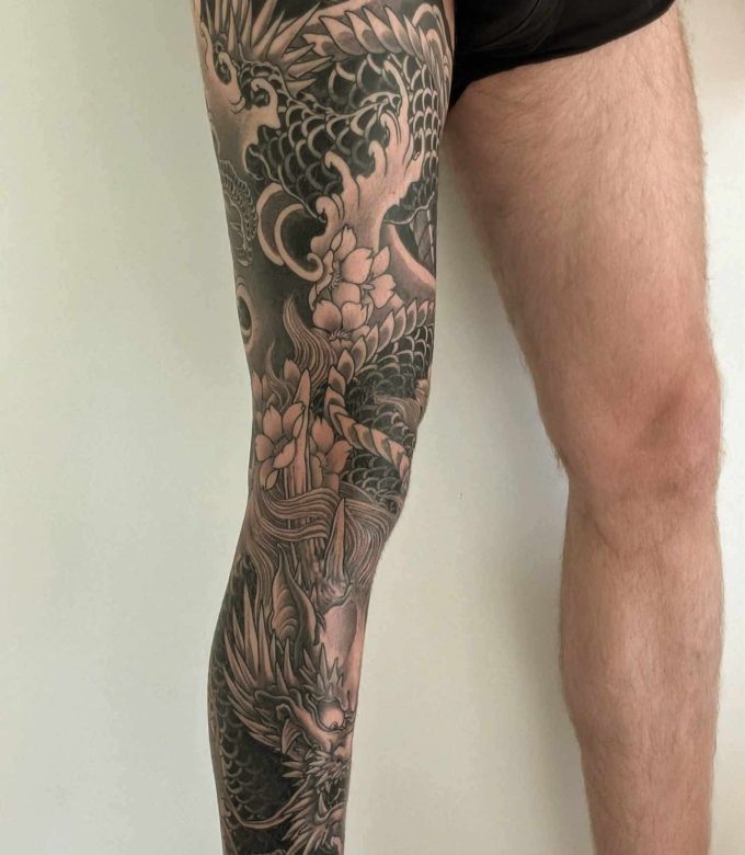 Japanese dragon full leg tattoo black and grey with peony flowers, traditional Japanese style tattoo by Dragonking Tattoo Pattaya