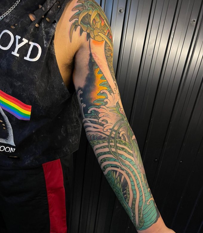 Green Japanese dragon full sleeve tattoo in neo-japanese style with flowing scales and bold color work, custom tattoo design