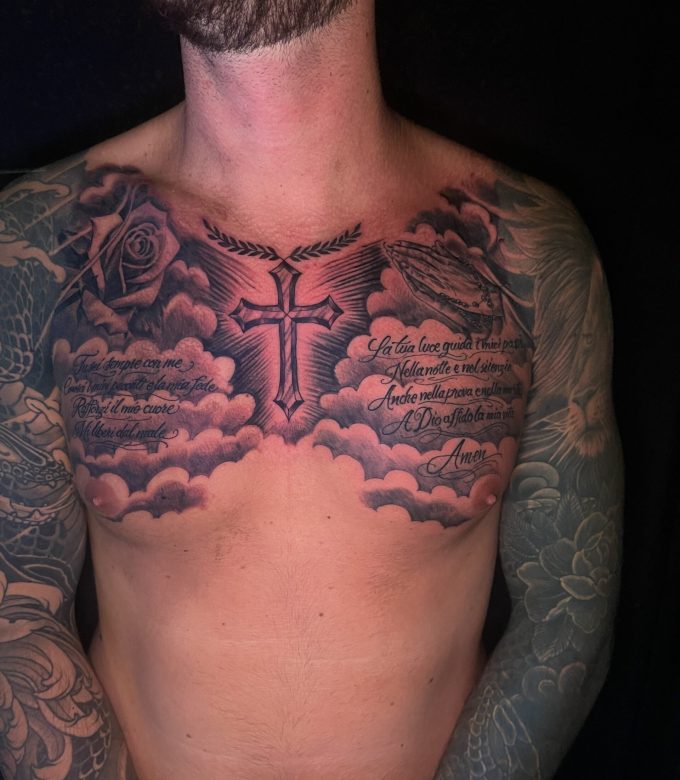 Custom religious chest tattoo with cross, prayer script and clouds by Dragonking Tattoo Pattaya