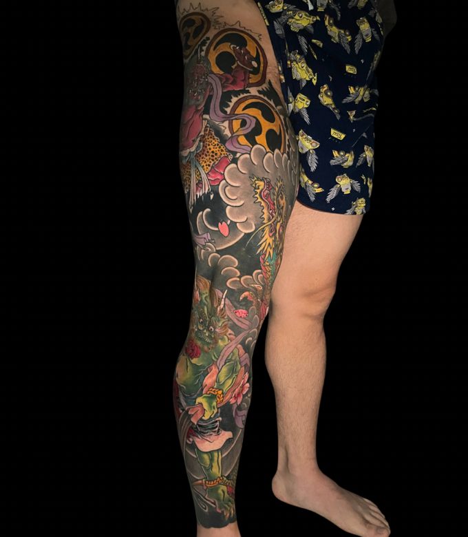 Color Japanese Oni leg sleeve tattoo with waves in Pattaya