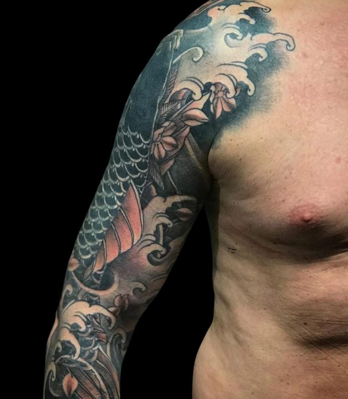 Japanese Irezumi Koi fish cover up tattoo with waves and cherry blossoms