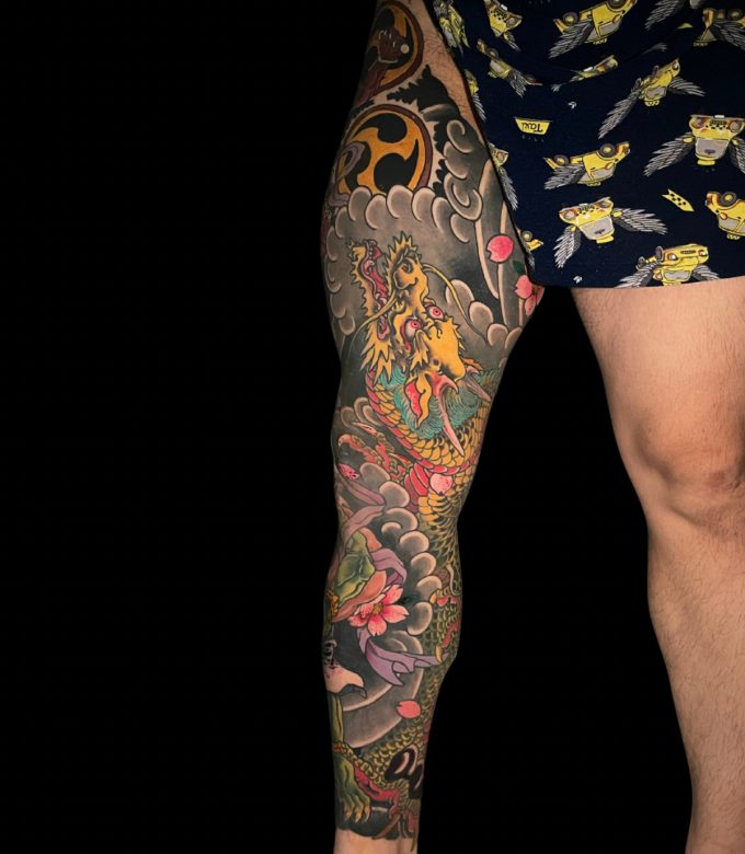 Yellow Japanese dragon leg tattoo with waves in Pattaya